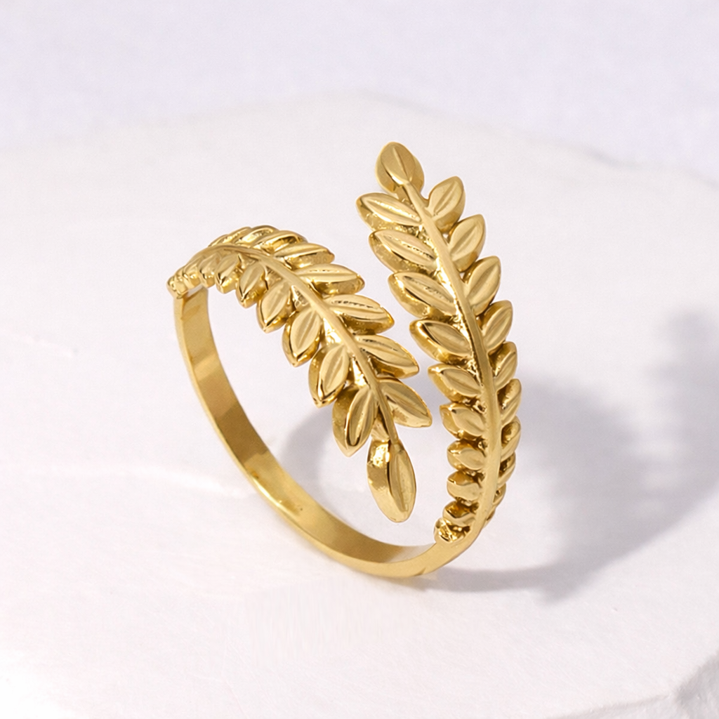 Gold leaf-shaped waterproof ring on a light gray background
