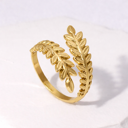 Gold leaf-shaped waterproof ring on a light gray background