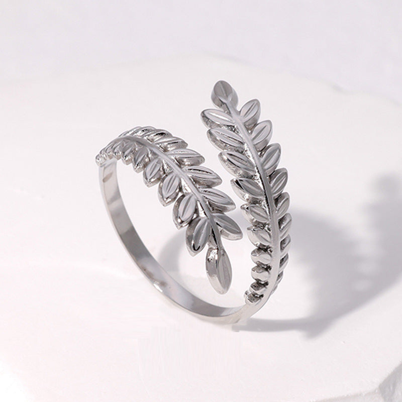 silver leaf-shaped ring on white background