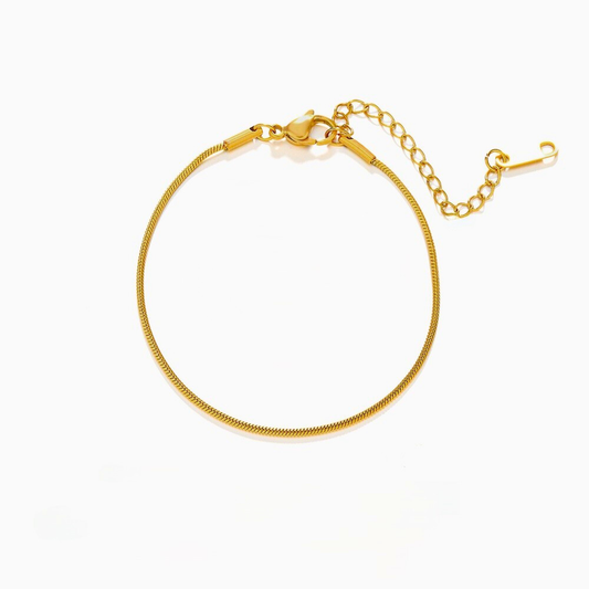 Gold stainless steel bracelet on a white background