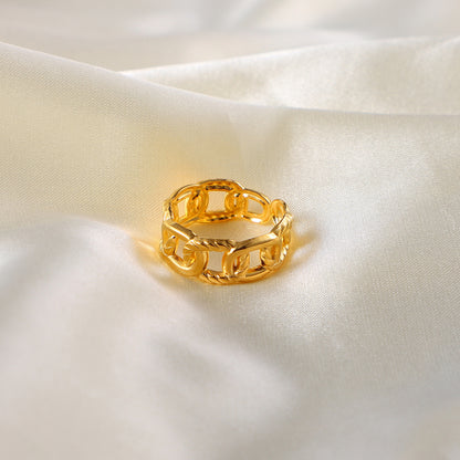 Gold stainless steel chain ring on a soft white fabric background