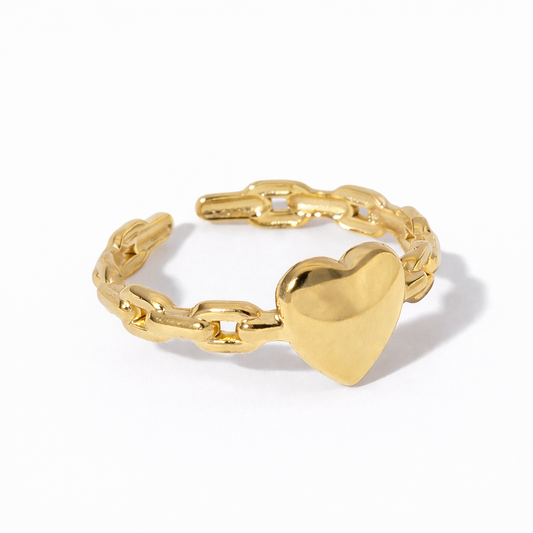 gold heart-shaped ring on white background