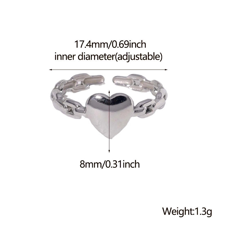 Silver ring with heart design and measurement details on a white background