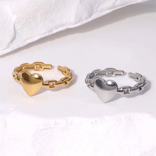 Gold and silver heart-shaped chain rings on a white background