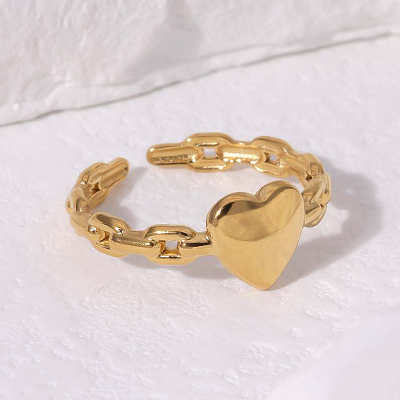 Gold chain ring with a heart-shaped padlock on a white background