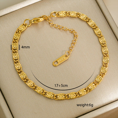 Gold chain bracelet with measurements on a beige background