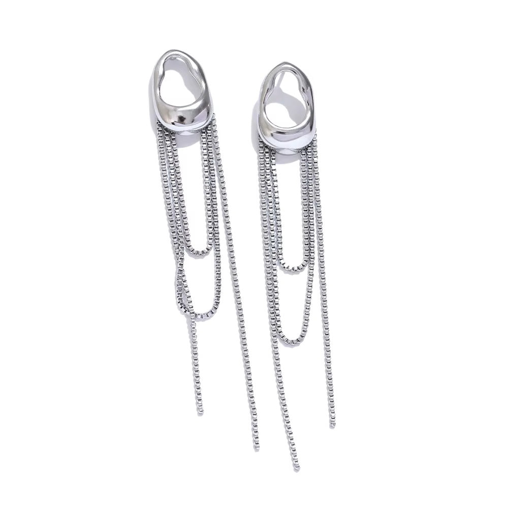 a pair of long silver statement steel earrings on white background