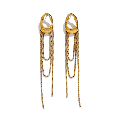Long dangly earrings in gold on white background