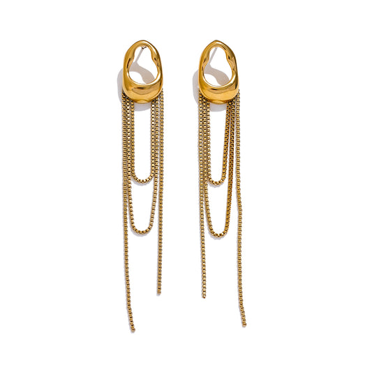 Long dangly earrings in gold on white background