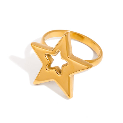 Gold star-shaped ring on a white background