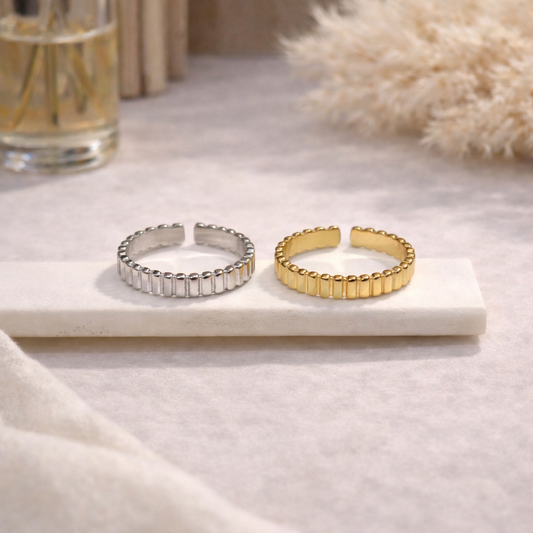 gold and silver minimalist rings on beige background