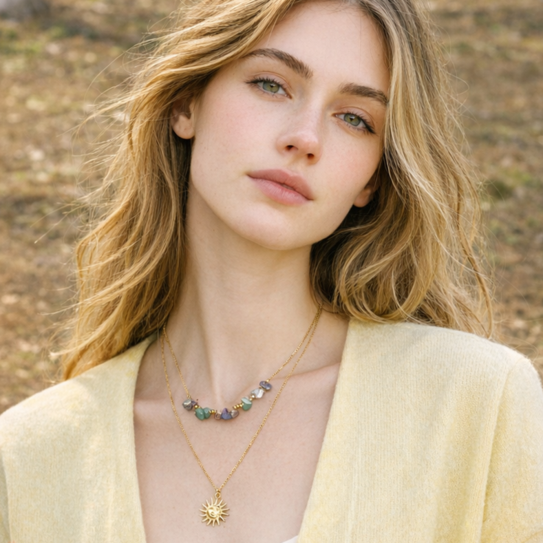 Woman wearing a necklace with a sun pendant in a natural setting