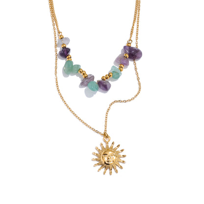 Necklace with sun pendant and multicolored beads on a white background