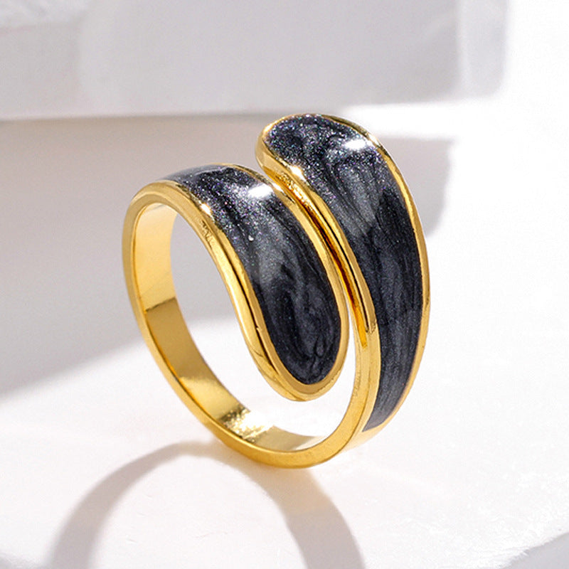 Gold and black tarnish-free ring on a white background