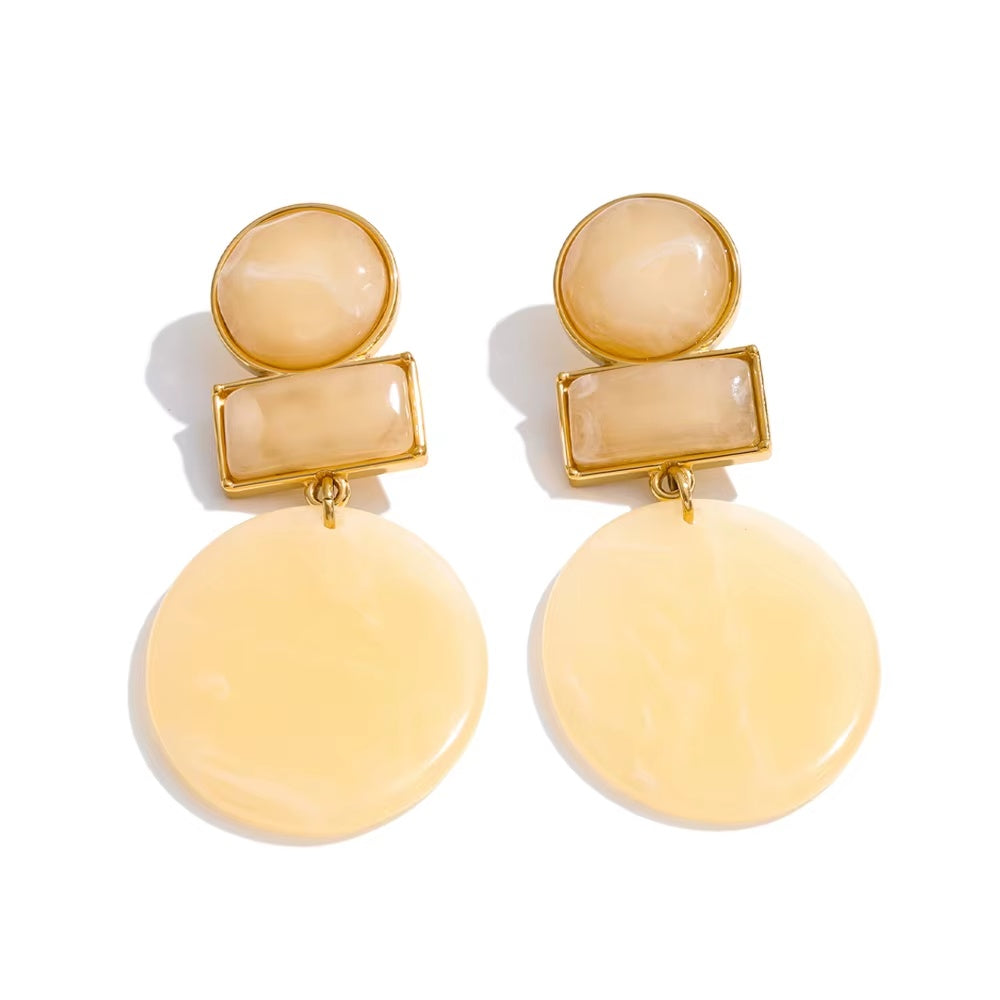 Pair of yellow earrings with gold accents on a white background