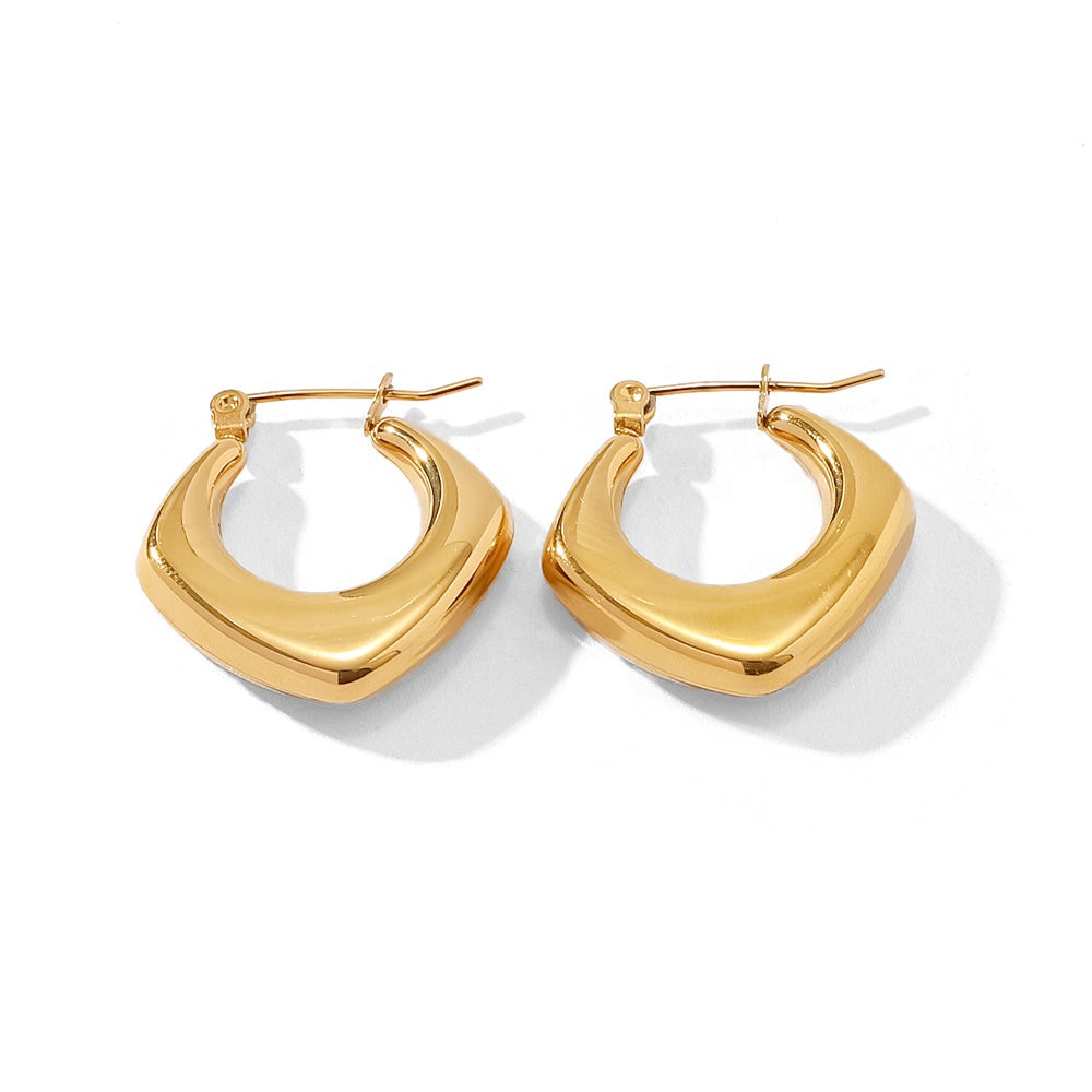 Gold hoop earrings on a white background