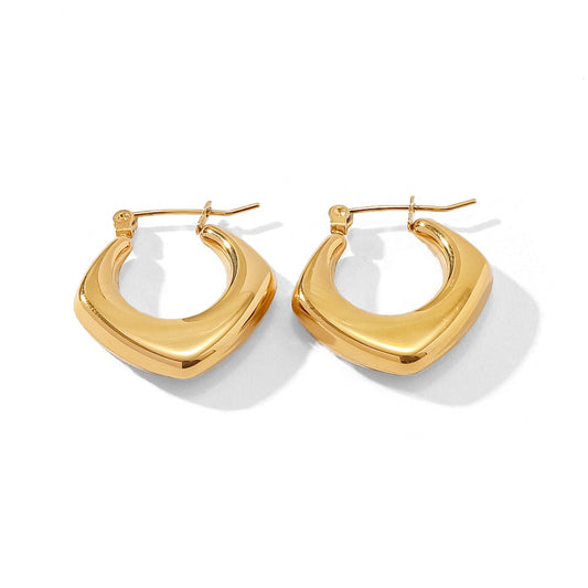 Gold hoop earrings on a white background