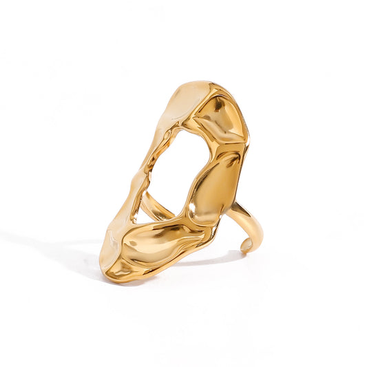 Gold statement ring with a modern design on a white background