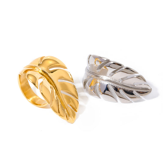 Gold and silver statement rings on a white background