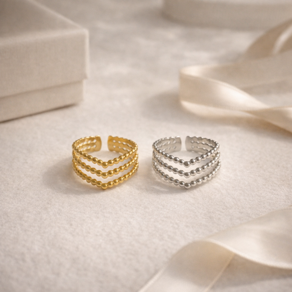 gold and silver beaded rings on white background