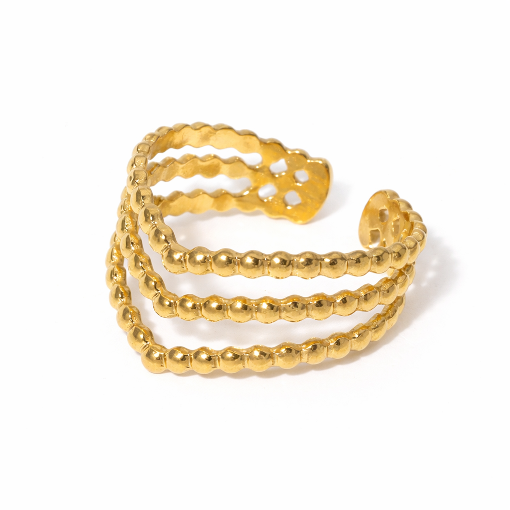 Gold beaded ring on a white background
