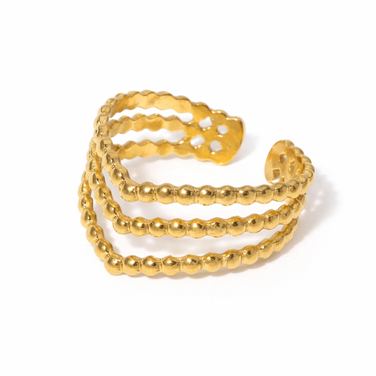 Gold beaded ring on a white background