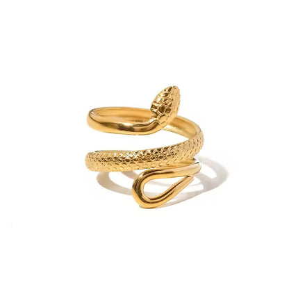 Gold snake-shaped ring on a white background