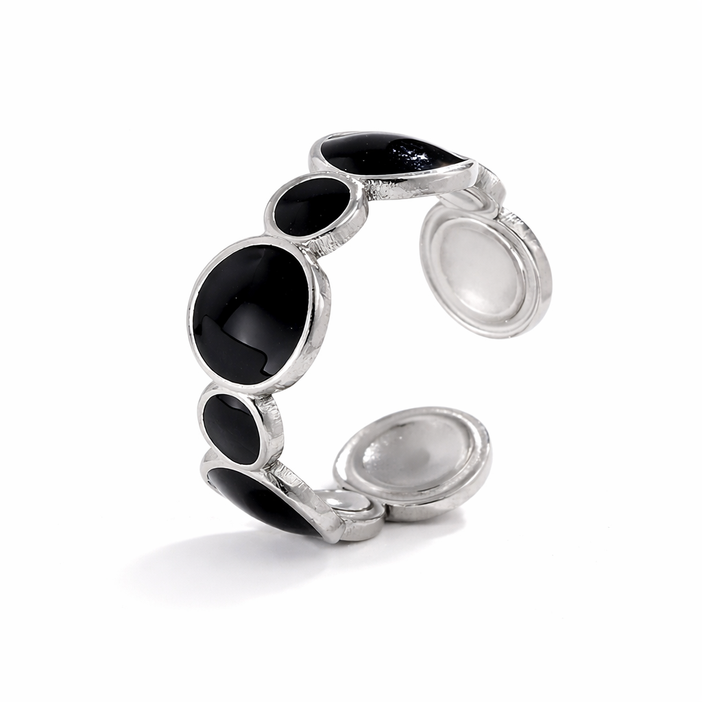 Silver tarnish-free ring with black gemstones on a white background
