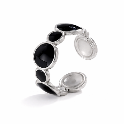 Silver tarnish-free ring with black gemstones on a white background