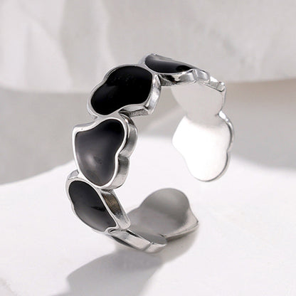 Silver tarnish-free ring with black heart-shaped stones on a white background