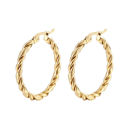 Pair of gold hoop earrings on a white background
