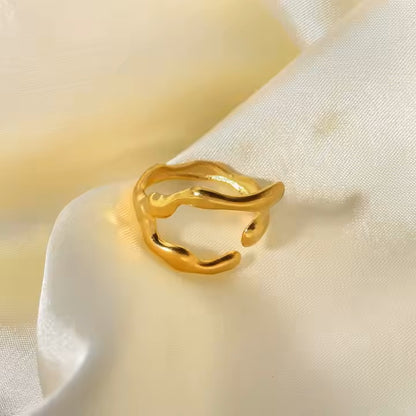 Gold ring on a soft beige fabric background