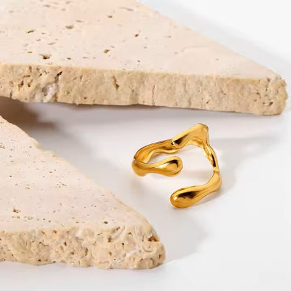 Gold ring on a light stone surface