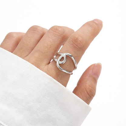 silver geometric ring on person's hand