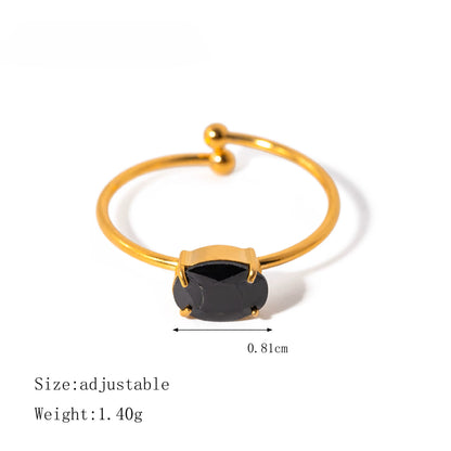 Gold ring with a black gemstone on a white background