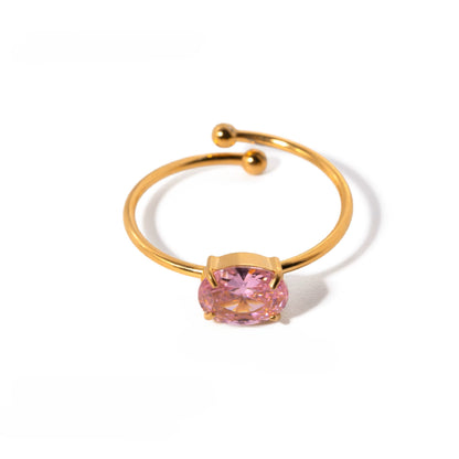 Gold ring with a pink gemstone on a white background