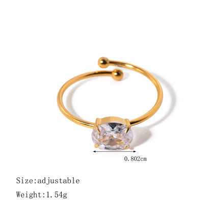 Gold ring with a clear gemstone on a white background