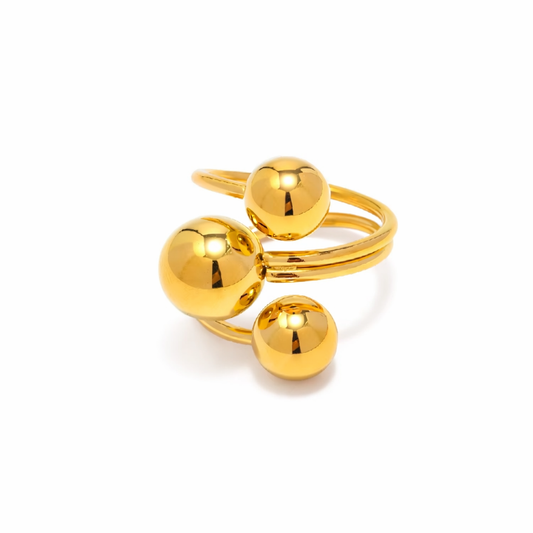 Gold chunky ring with three spherical components on a white background