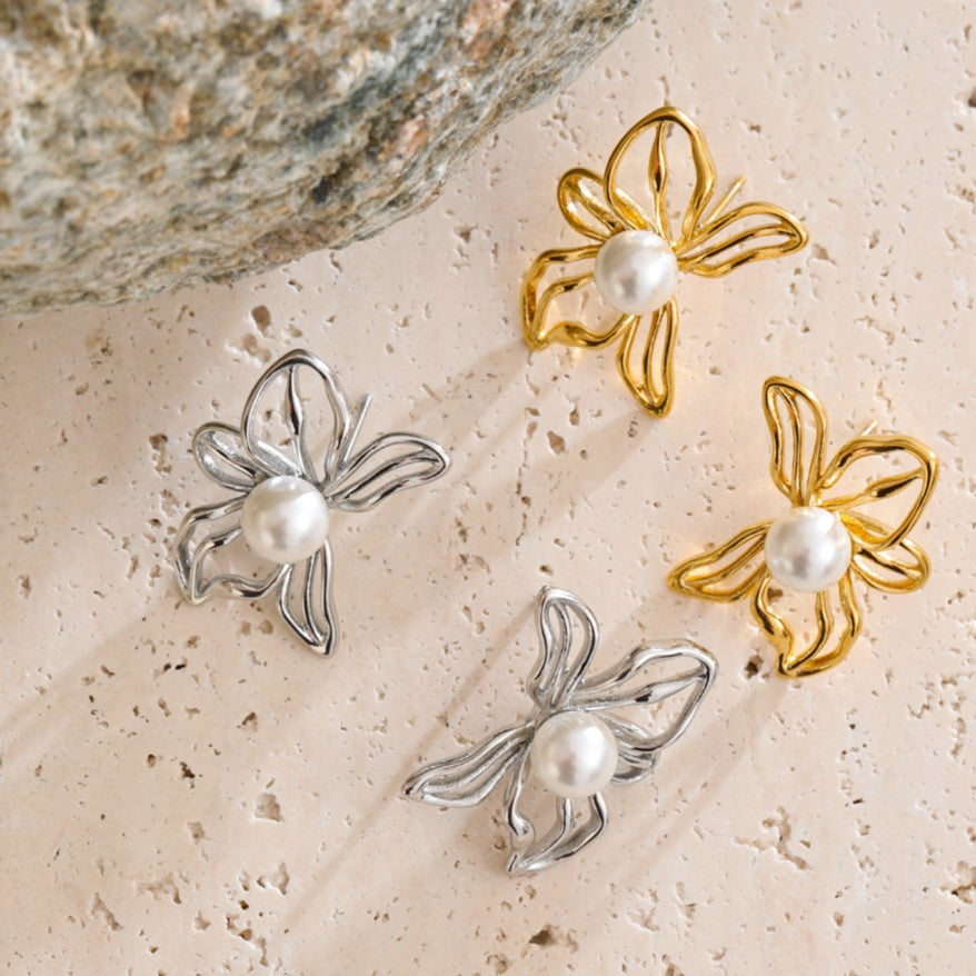 elegant gold and silver studs in the shape of flower with pearl center