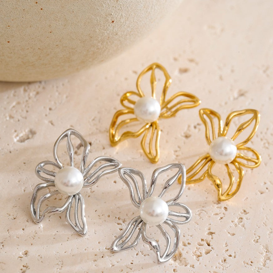 elegant gold and silver studs in the shape of flower with pearl center