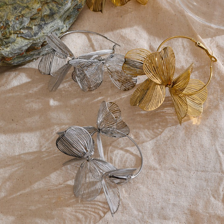 gold and silver hoop earrings with floral design