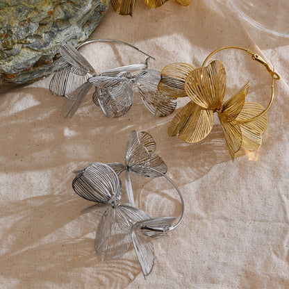 gold and silver hoop earrings with floral design