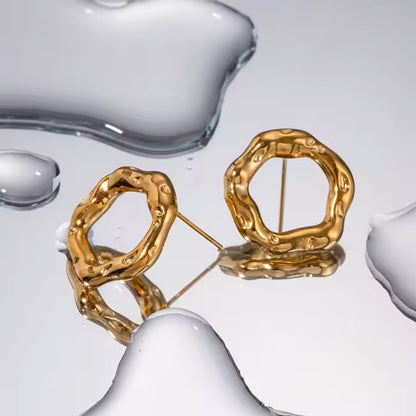 Gold stainless steel earrings on a white background