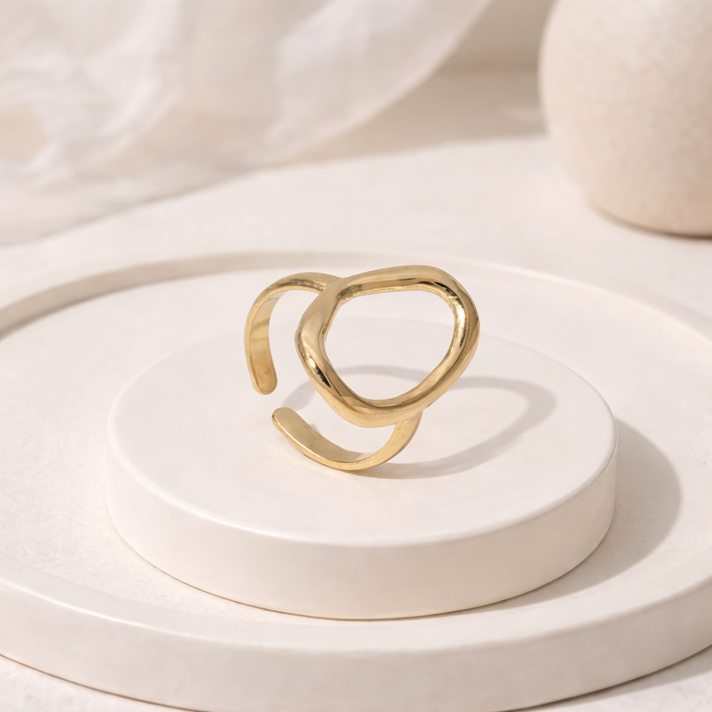 Gold waterproof ring with a unique design on a white surface