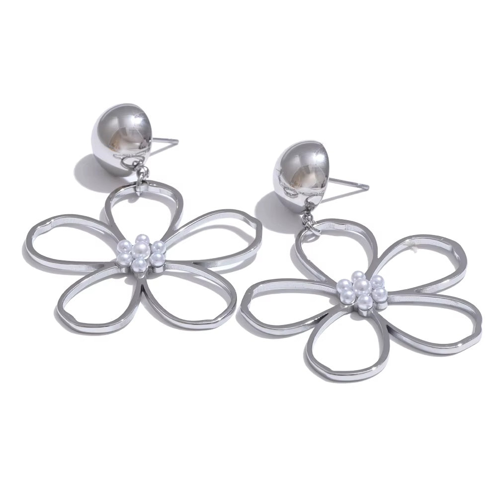 Silver flower-shaped earrings on a white background