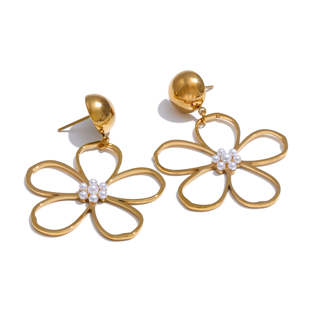 Gold flower-shaped earrings with pearl centers on a white background