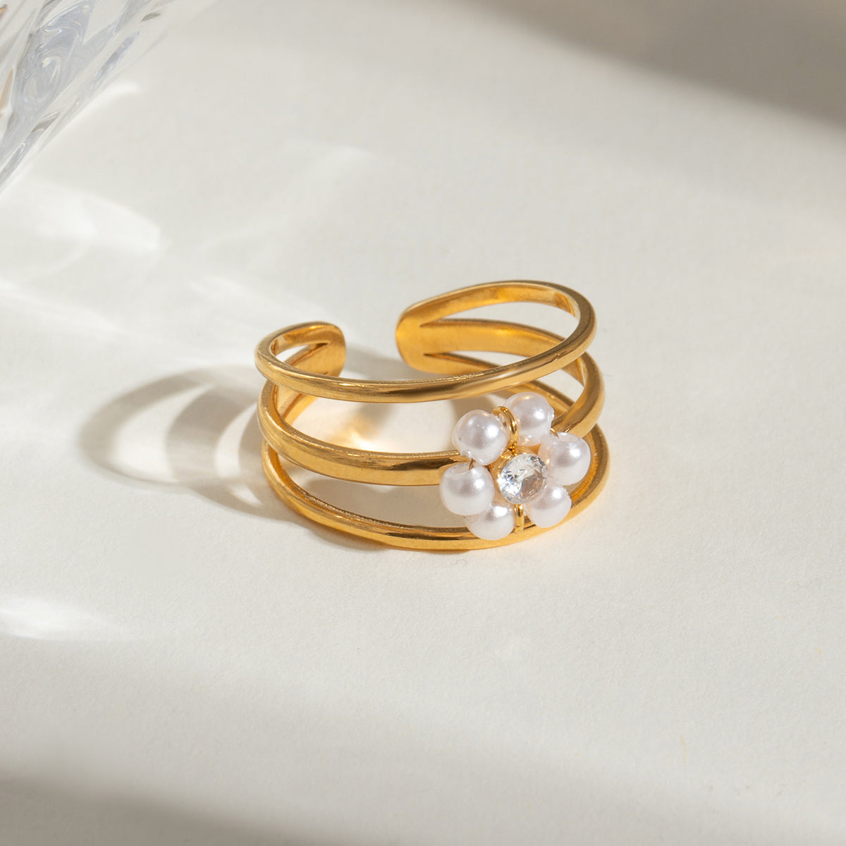 Gold ring with pearls on a light background