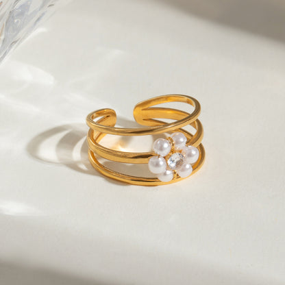 Gold ring with pearls on a light background