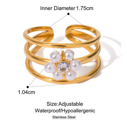Gold ring with pearl and crystal design, showing measurements and material details.