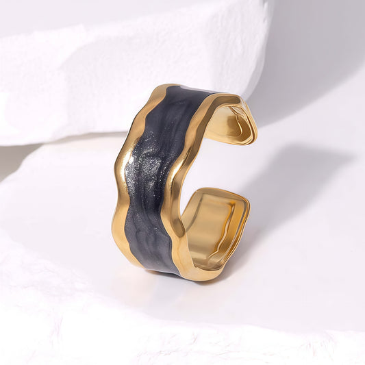 Gold and black waterproof ring on a white background